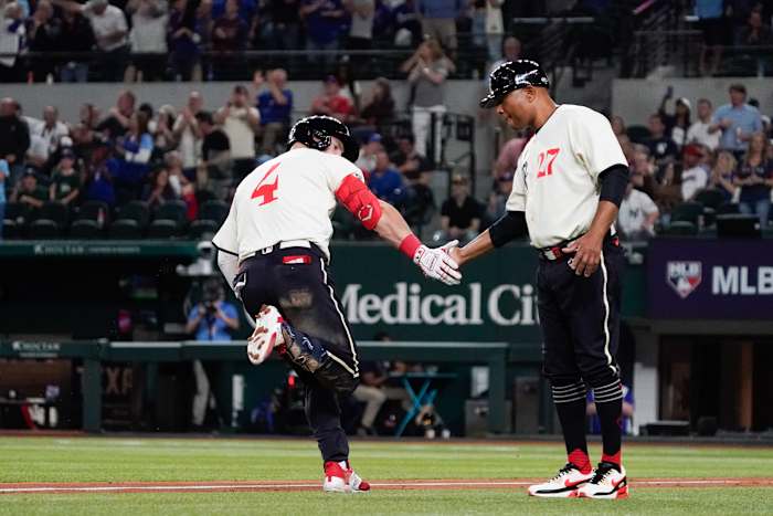 Texas Rangers right fielder Robbie Grossman celebrates with third base coach Tony Beasley as he circles the bases after a two-run home run against the New York Yankees on April 28 at Globe Life Field.